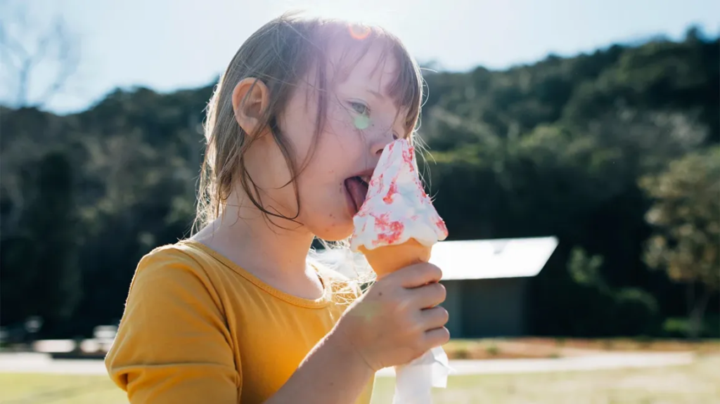 A picture that shows a child enjoying the sweet taste